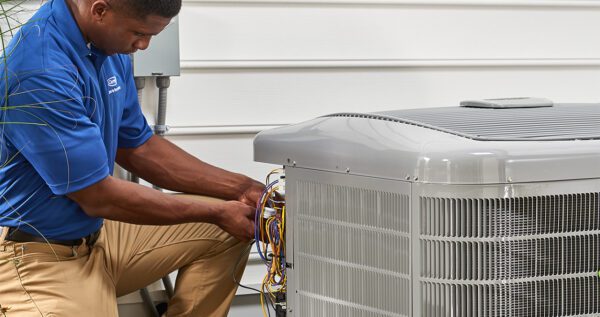 Man Fixing Air Conditioner in Des Moines IA